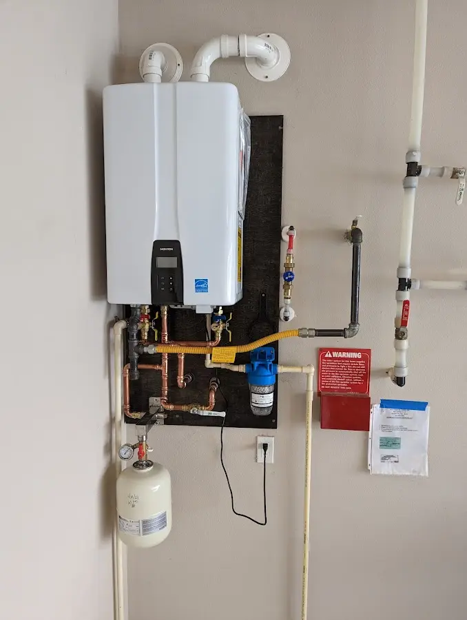 Professional plumber installing copper piping in a Burley home